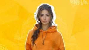 A young woman in an orange hoodie symbolizing influencer outreach for brand relationship building with a cultural architecture background