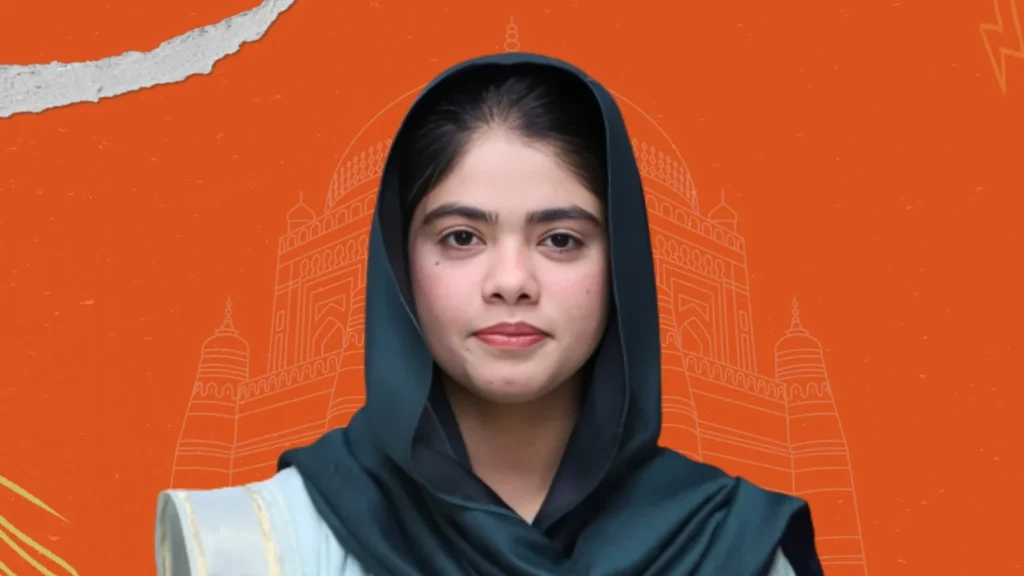 Close-up portrait of a woman in traditional dress with Multan heritage backdrop