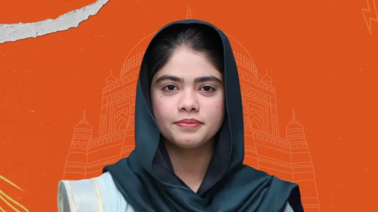 Close-up portrait of a woman in traditional dress with Multan heritage backdrop