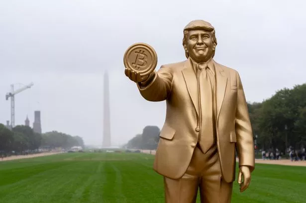 A 12-foot golden statue of Trump holding Bitcoin outside the US Capitol ignites debates on cryptocurrency, policy, and the future of money in America.