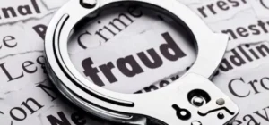 Handcuffs placed on a fraud-themed background representing crime and arrests