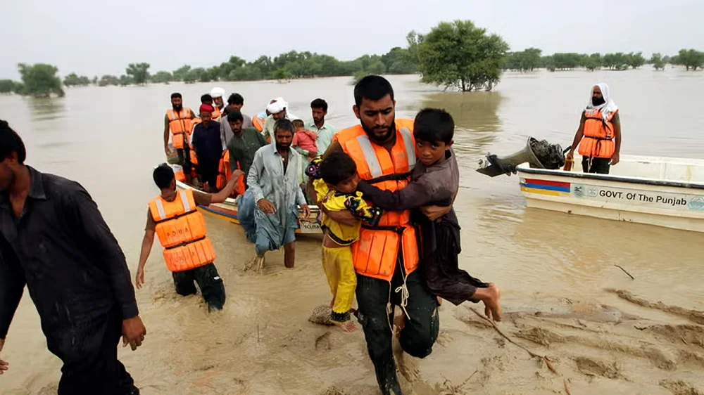 Volunteers rescuing children and families from floodwaters in Punjab