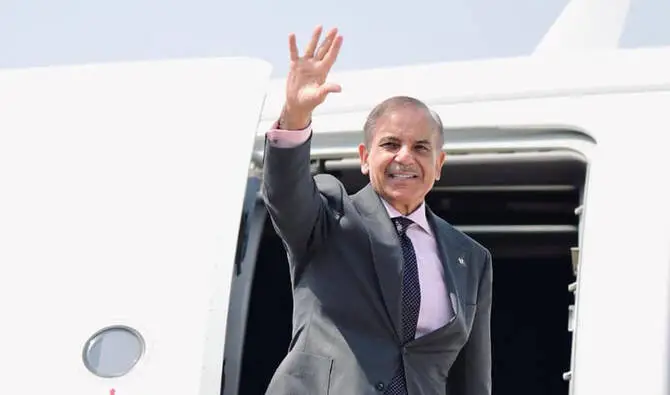 PM Shehbaz Sharif waves while departing for Arab-Islamic Summit in Doha