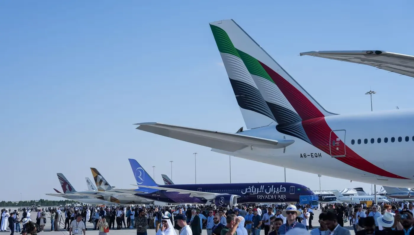 Multiple international airlines including Emirates, Qatar Airways, Etihad, and Riyadh Air parked at an airport during an aviation event