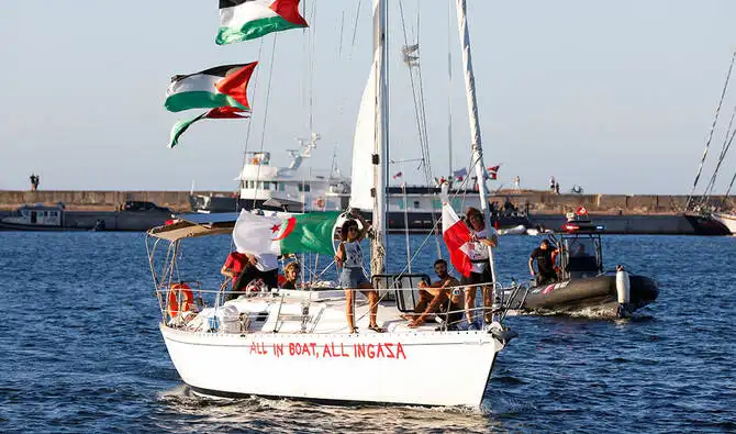 Gaza Aid Flotilla boat carrying activists with flags, part of the mission to break the blockade on Gaza.