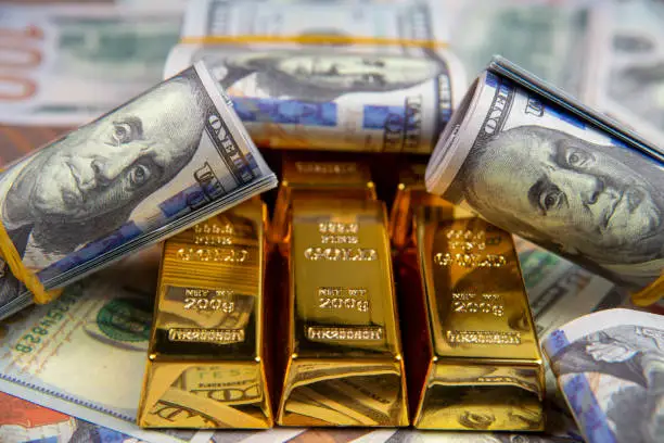 Gold bars surrounded by US dollar bills representing gold surpassing $30 trillion market value