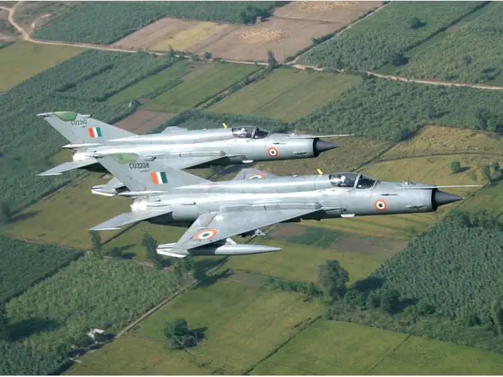 Indian Air Force fighter jets flying in formation over green fields symbolizing India’s defense advancements