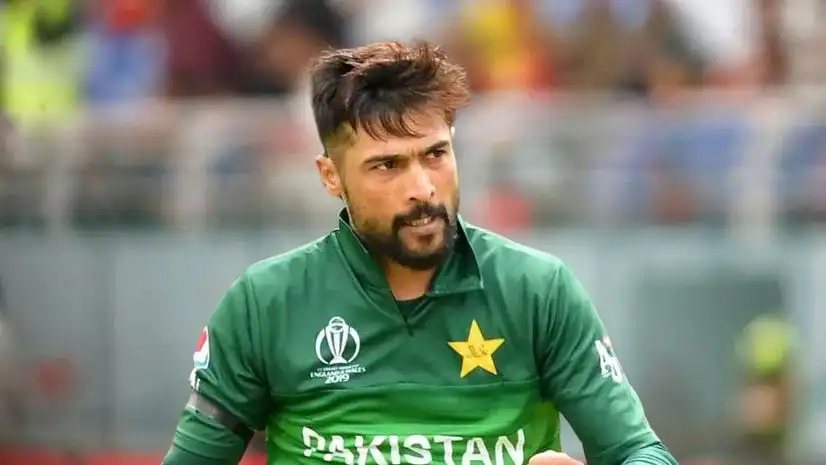 Pakistani cricketer Mohammad Amir celebrating after taking a wicket during an international match.