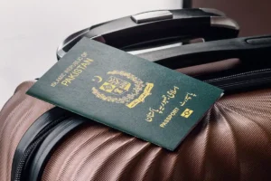 New green Pakistan passport placed on luggage, representing the redesigned document featuring historic places from across the country