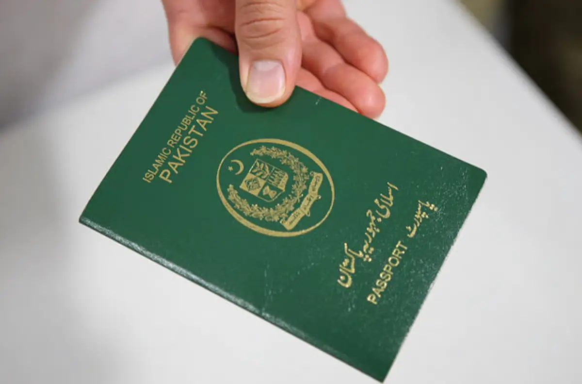 A person holding a Pakistani passport representing Pakistan visa-free countries 2025