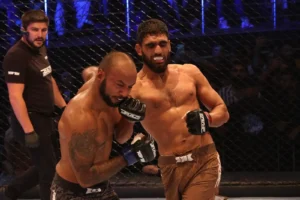 Pakistani MMA fighter Rizwan Ali competing in the cage during an intense match, representing his dominance in MMA against India