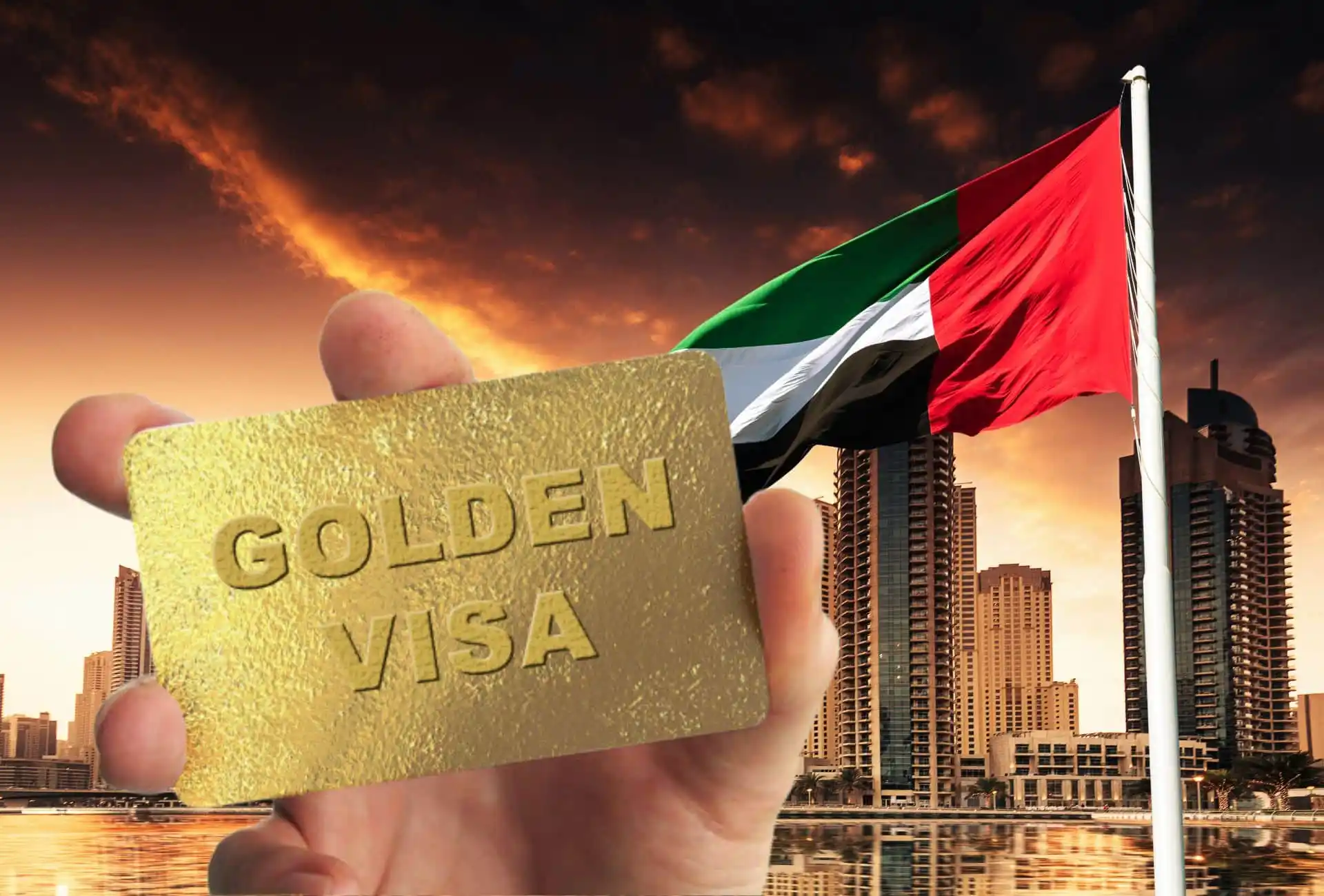 UAE Golden Visa card held with national flag and Dubai skyline in the background