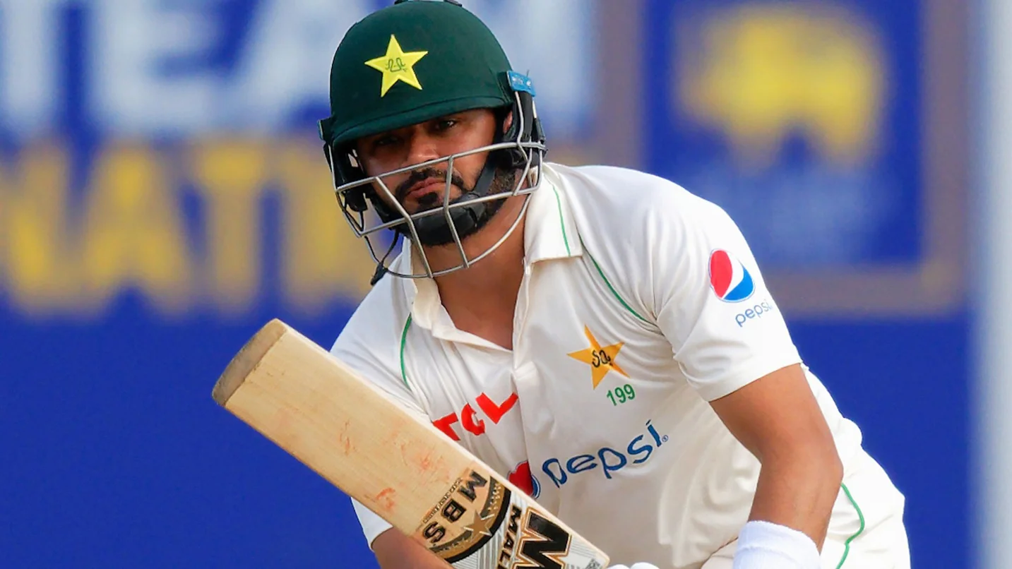 A cricketer in a white uniform playing a batting shot during a match, used for the Azhar Ali resignation article.