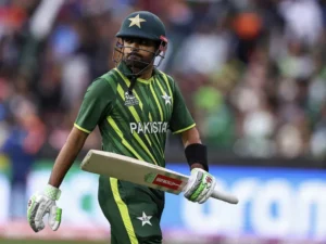 Babar Azam walking off the field holding his bat during a T20 match, representing Babar Azam Form slump