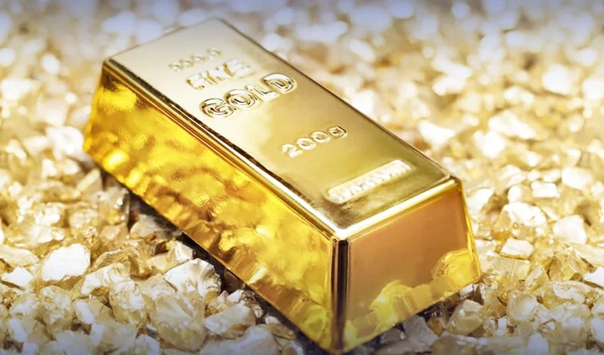 A 200g gold bar surrounded by gold nuggets, symbolizing the recent surge in gold prices in Pakistan.