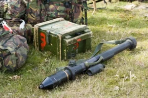 A military anti-tank weapon placed on grass beside ammunition boxes, used for the India US defence sale article.