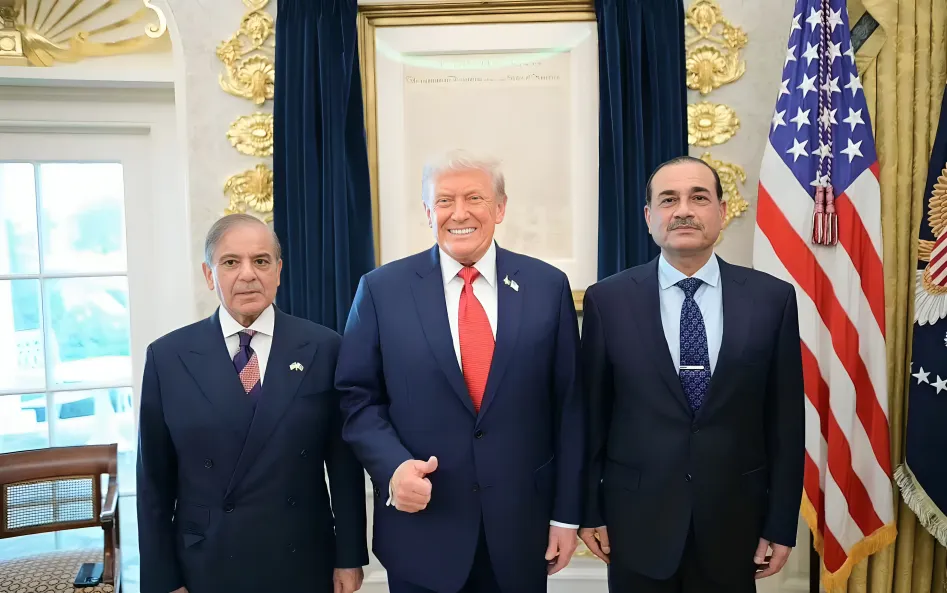 Three men standing together in a formal office setting with flags in the background, representing Pakistan Gaza Support