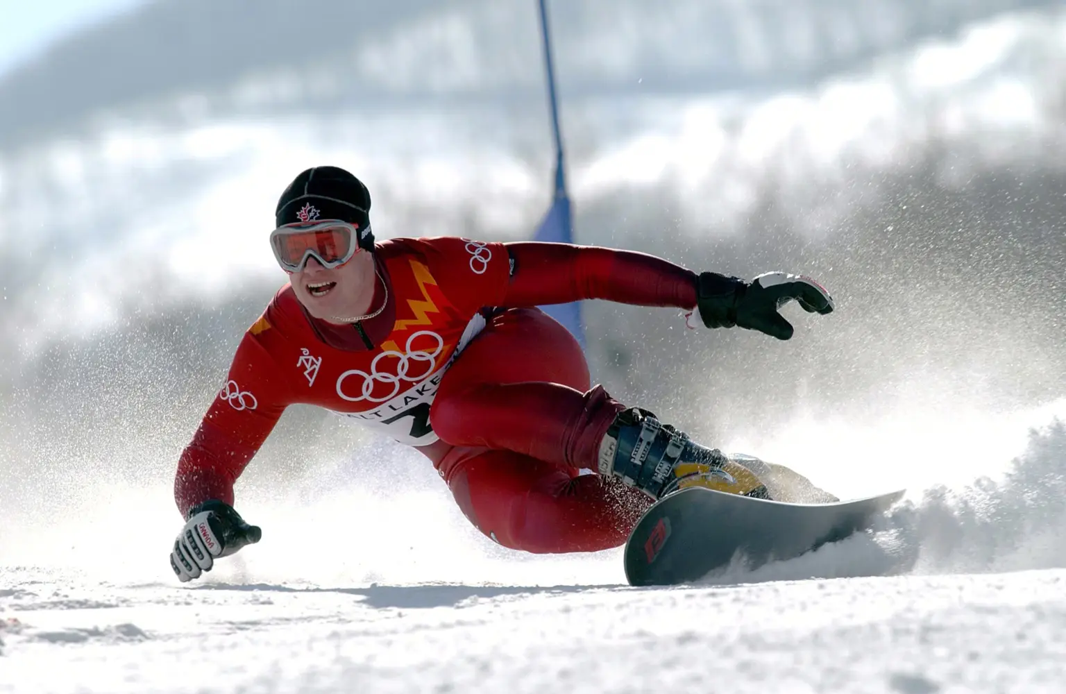 A former Olympic snowboarder in action, showcasing athleticism during a race.