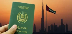 Pakistani passport held against the Dubai skyline with UAE flag in the background