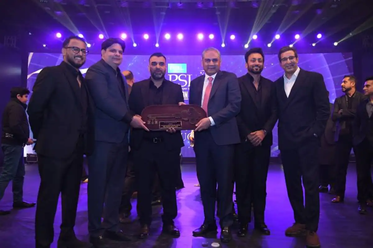 OZ Group bonus celebration after acquiring PSL Sialkot franchise as executives receive trophy on stage