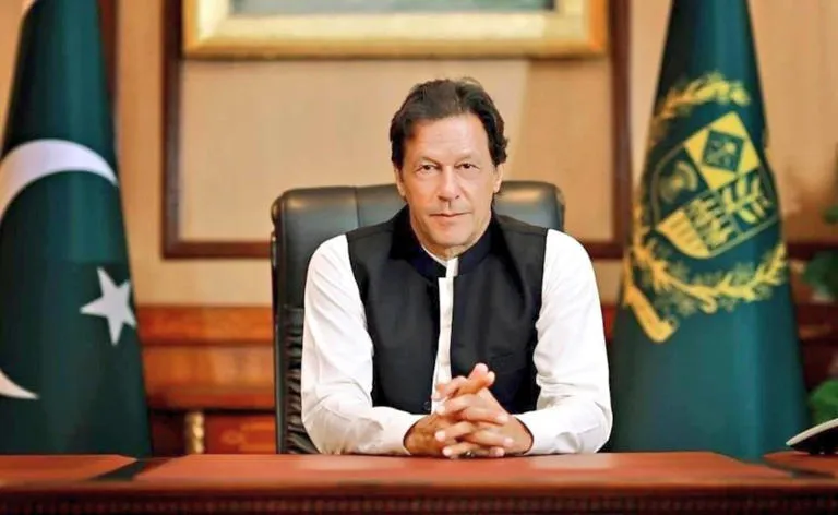 Imran Khan seated at his desk as Imran Khan sisters criticise PTI leadership