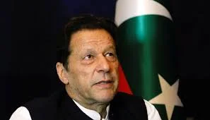 Close-up portrait of a Pakistani political leader with Pakistan flag in background