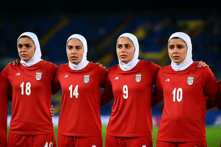 Iran women football team standing together on stadium field during AFC Women's Asian Cup in Australia, showing unity and concern