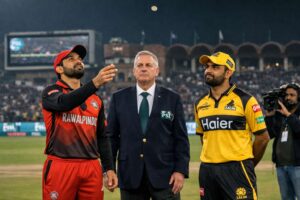 Mohammad Rizwan of RawalPindiz tosses the coin as Babar Azam of Peshawar Zalmi looks on during PSL 11 toss at Gaddafi Stadium