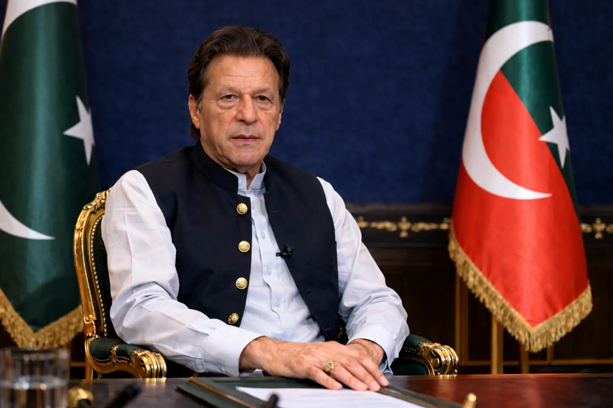 Former Prime Minister Imran Khan addressing political situation in Pakistan with national flags in background