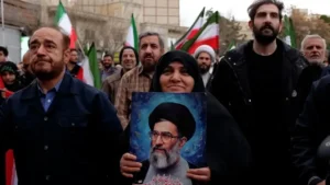Supporters in Iran holding portrait during protests reflecting Iran leadership crisis after assassination