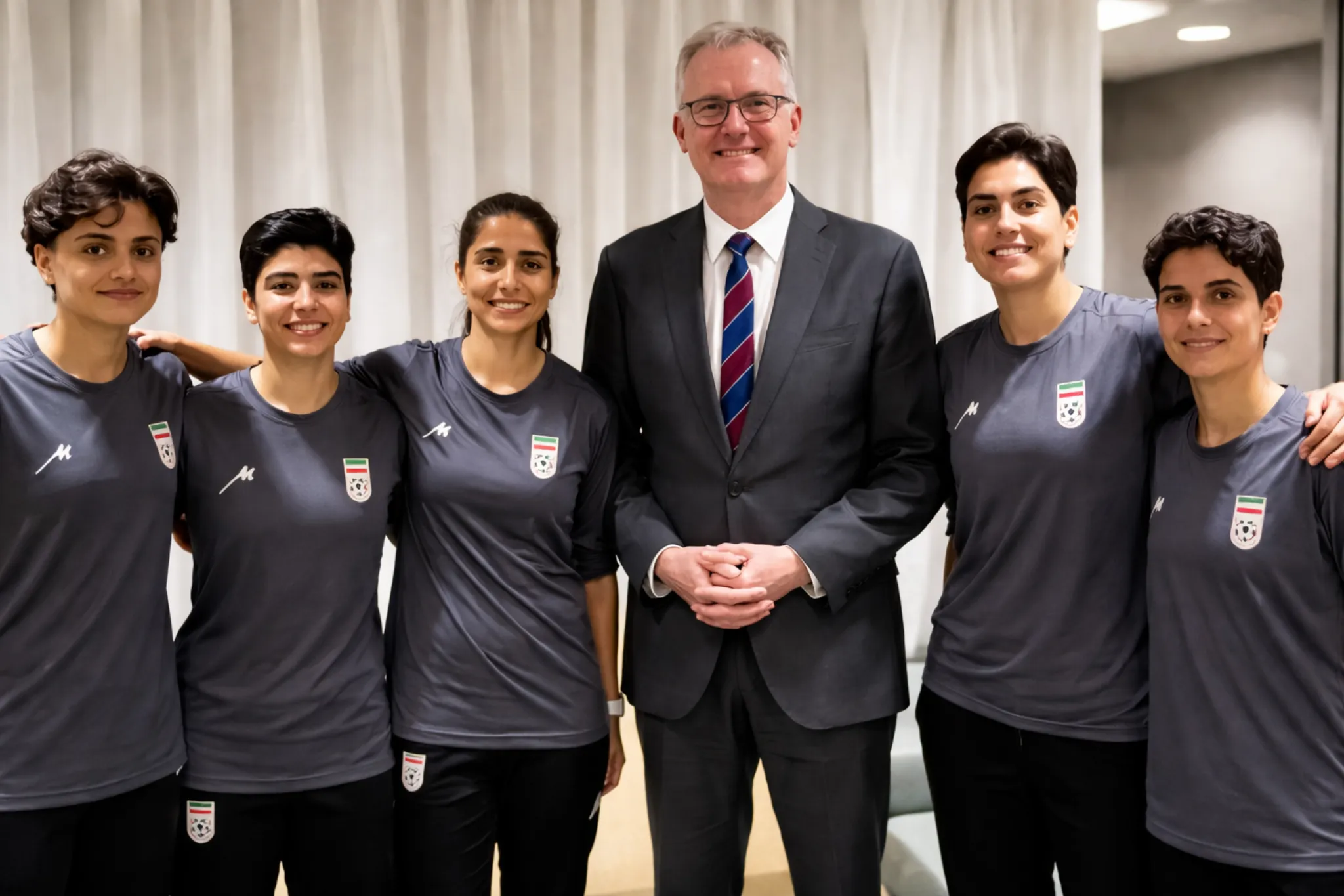 Iranian women football players posing with an Australian official after receiving humanitarian visas and asylum in Australia