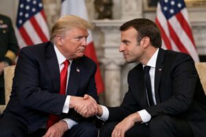 US President Donald Trump shakes hands with French President Emmanuel Macron during a formal meeting, highlighting Trump Macron relations.