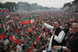 Large crowd gathered at PTI rally in Rawalpindi waving flags during political gathering