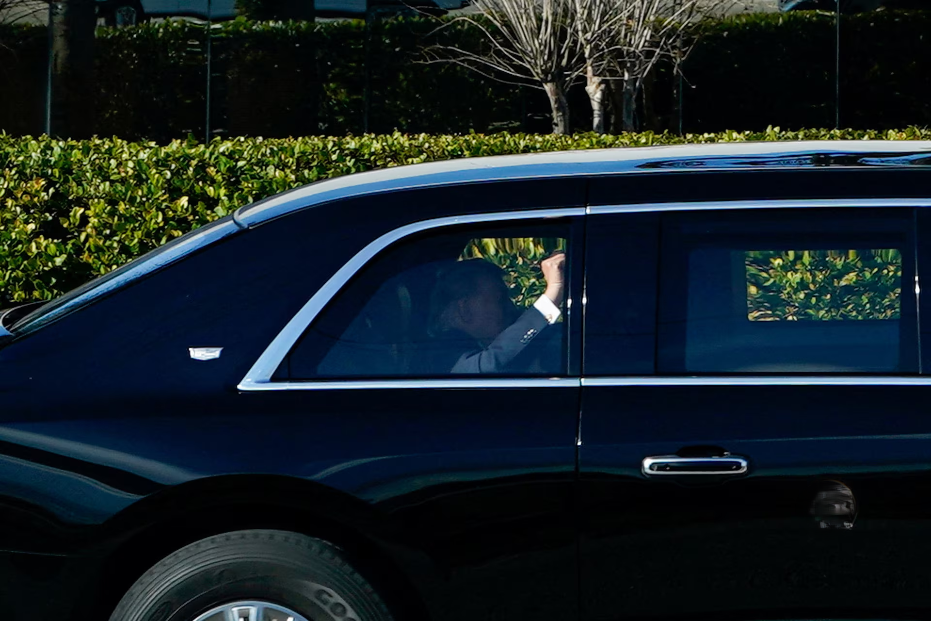 US President Donald Trump gestures from his motorcade in Miami, discussing how Trump oil prices might impact the upcoming midterm elections.
