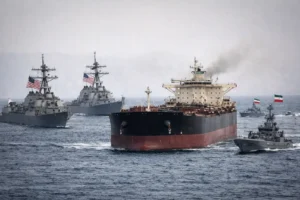 US Iran blockade scene with oil tanker and naval ships in Strait of Hormuz showing rising tensions