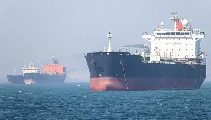 Cargo vessels and tankers in the Strait of Hormuz during the Project Freedom pause announcement.