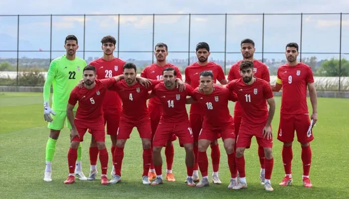 Iran national football team players posing on the pitch in Antalya, Turkey, during a friendly match ahead of the FIFA World Cup.