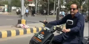 Murtaza Wahab riding an electric bike without helmet near Sindh Assembly