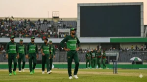 Pakistani cricketers looking downcast at Sher-e-Bangla National Stadium as scoreboard displays '40% match fee fine' and '8 WTC points deducted' for Pakistan slow over-rate.
