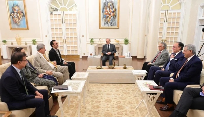 Prime Minister Shehbaz Sharif hosting a high-level meeting with Bilawal Bhutto Zardari, Ishaq Dar, and other political leaders in a formal sitting room.