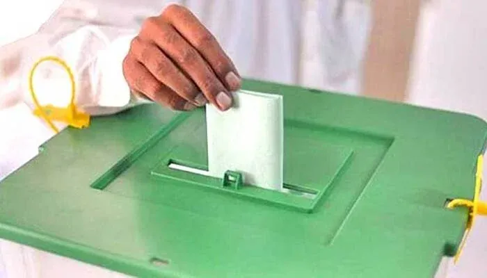 AJK elections voting process showing a voter casting a ballot during the election.
