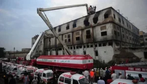 Baldia factory fire damaged building after the Karachi industrial tragedy with emergency response teams at the site.