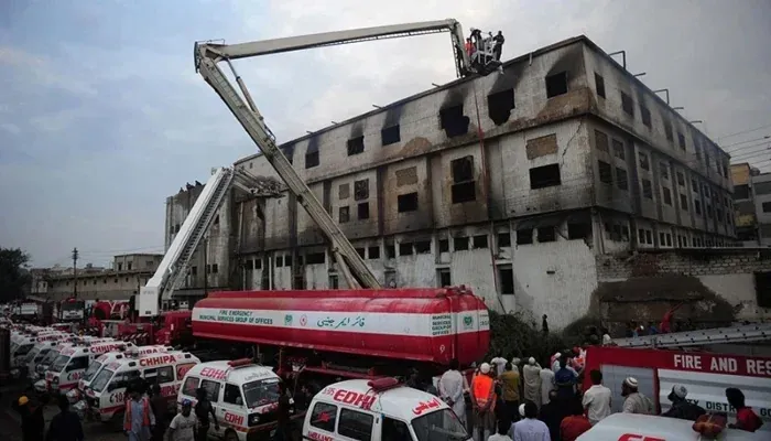Baldia factory fire damaged building after the Karachi industrial tragedy with emergency response teams at the site.