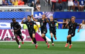 Canada players celebrate Stephen Eustaquio's late winning goal during the Canada World Cup Round of 16 match against South Africa.
