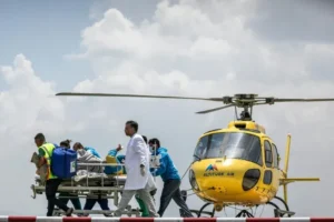 Medical team transports Everest Survivor Dawa Sherpa to a rescue helicopter after being found alive on Mount Everest.