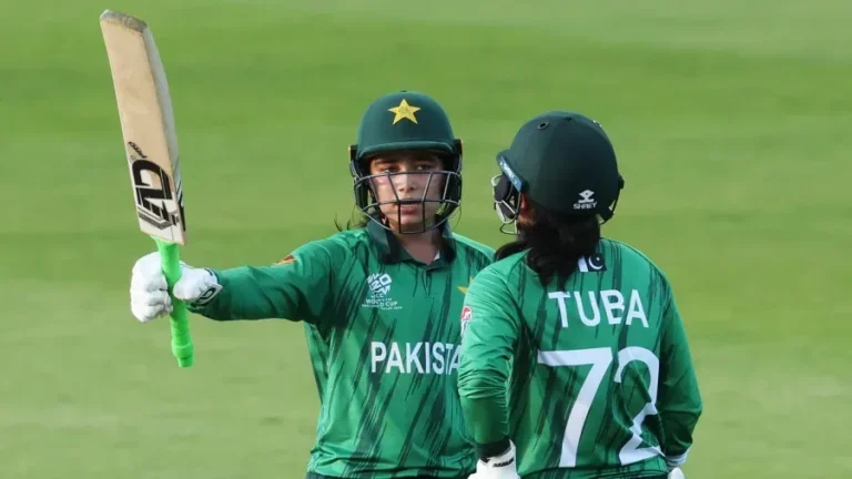 Fatima Sana raises her bat during a match after becoming the first Pakistani woman selected for The Hundred