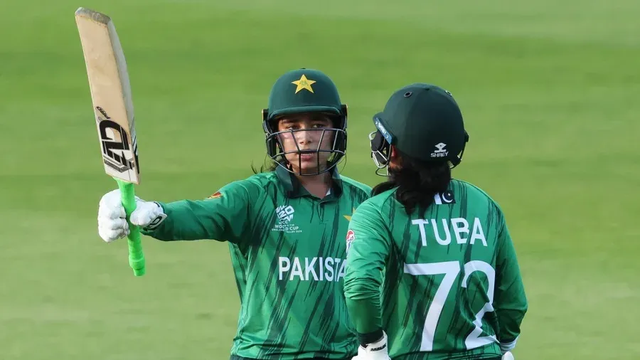 Fatima Sana raises her bat during a match after becoming the first Pakistani woman selected for The Hundred
