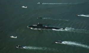 Pakistan Navy Hangor submarine sailing near Karachi with naval boats and helicopters during a ceremonial welcome