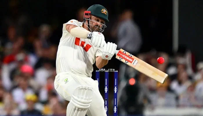 Australian batter playing a shot with the ICC Pink Ball during a Test cricket match