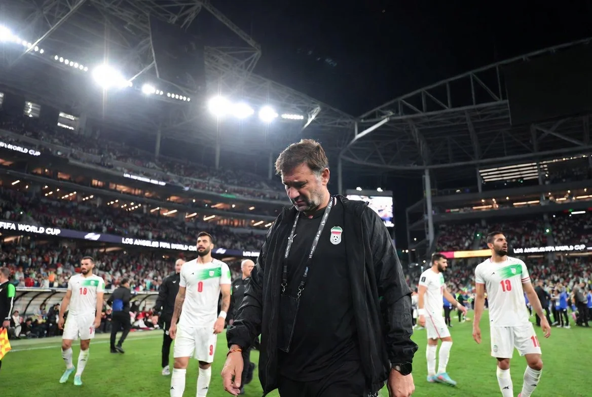Iran World Cup coach Amir Ghalenoei walking off the pitch looking exhausted and frustrated after the match against New Zealand at the 2026 FIFA World Cup in Los Angeles, highlighting the team's logistical challenges
